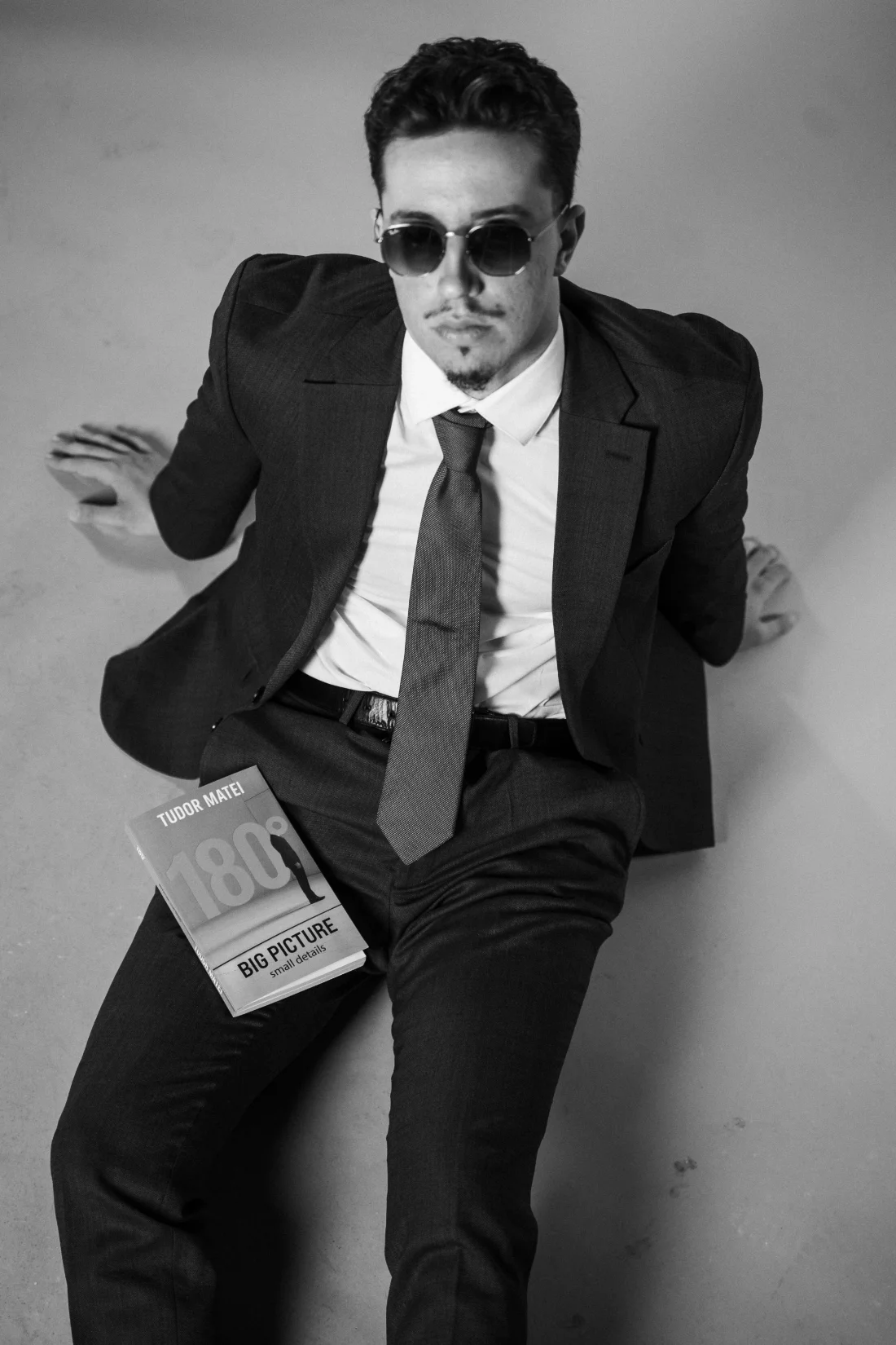 Tudor Matei seated with the 180 Degrees book